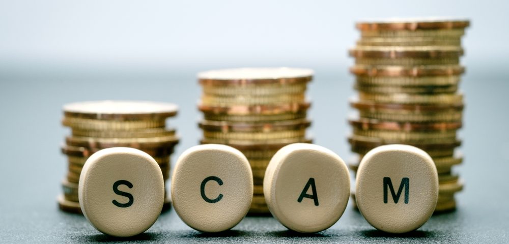 Coins and keyboard letters that read SCAM