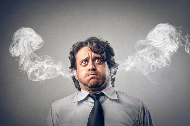 a man wearing a tie with smoke coming out of his ears