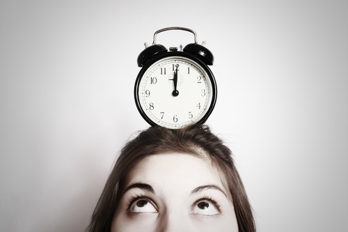 a woman waiting with a clock on her head
