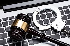 a gravel and handcuffs lie on a keyboard
