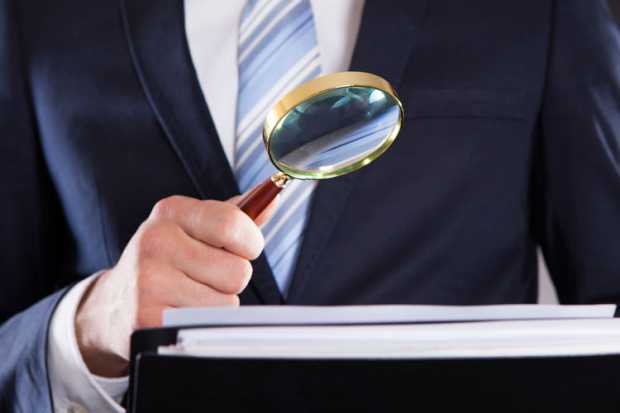 A claims handler checks paperwork for negligence